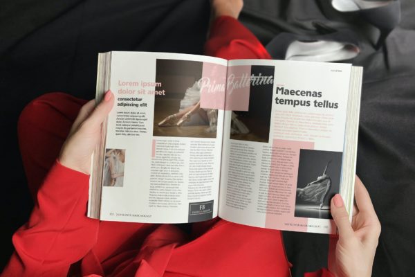 红衣女人手拿软皮书效果图展示样机 Woman In Red With Softcover Book Mockup