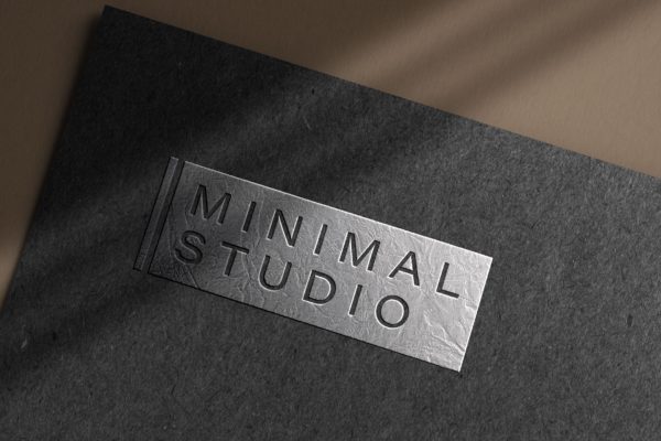 深色纸浮雕效果银色Logo样机 Embossed silver logo mockup on dark paper