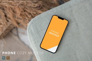 布艺沙发背景iPhone 13 Pro Max手机样机模板 iPhone 13 Pro Max Cozy Background Home Mockup